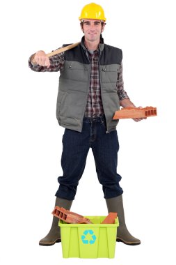 Construction worker stood with recyclable waste material clipart