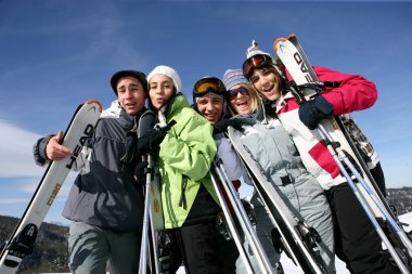 A group of friends on a skiing holiday clipart
