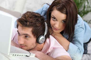 Man absorbed by his music and ignoring his girlfriend clipart