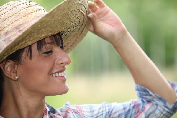 Young woman in a straw hat — Stock Photo, Image