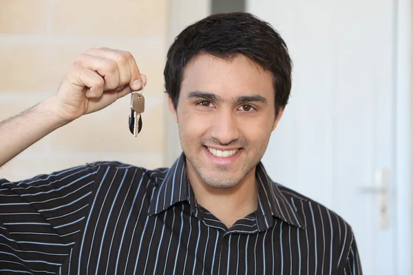 Young man with a doorkey — Stock Photo, Image