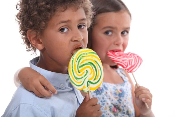 Couple of children with lollypops — Stock Photo, Image