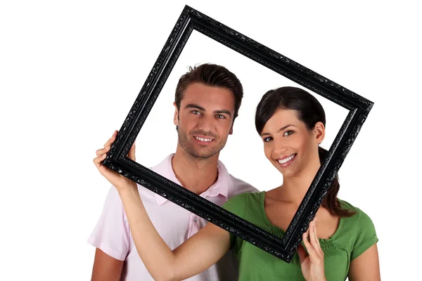 Man and woman withframe — Stock Photo, Image