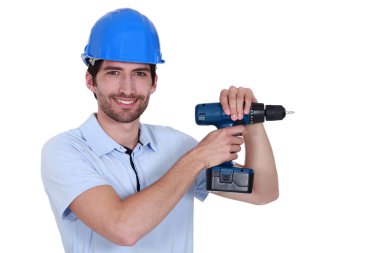 Unshaven worker with power drill clipart