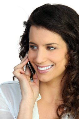 Attractive woman talking on her mobile phone clipart