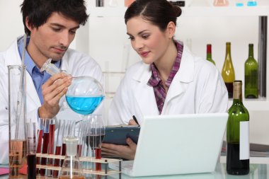 Oenologists working in a lab clipart