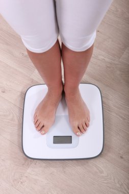 Woman weighing herself clipart