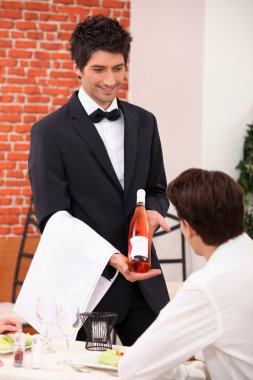 Sommelier presenting a wine clipart