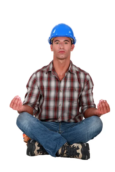 A male construction worker in a yoga position. — Stock Photo, Image