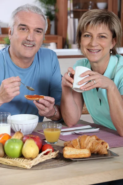 Smiling couple at breakfast — Stock Photo, Image