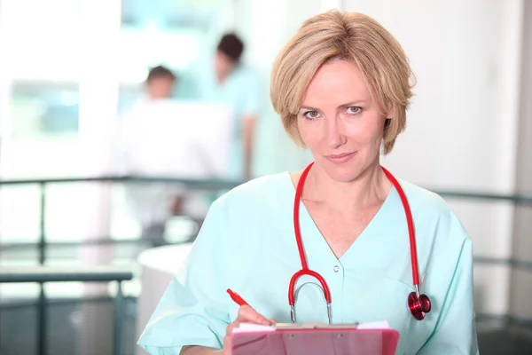 Enfermera escribiendo en el portapapeles —  Fotos de Stock