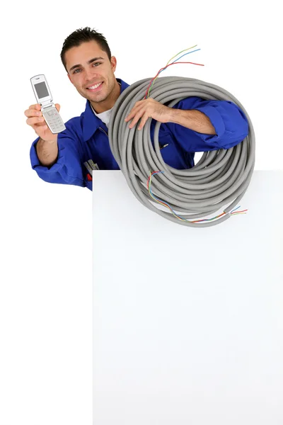 Electrician with a cellphone — Stock Photo, Image