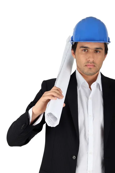 Architect carrying plans in front of white background — Stock Photo, Image