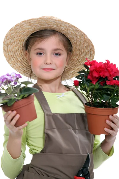 Menina segurando vasos de flores — Fotografia de Stock