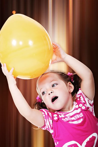 Little girl holding balloon — Stock Photo, Image