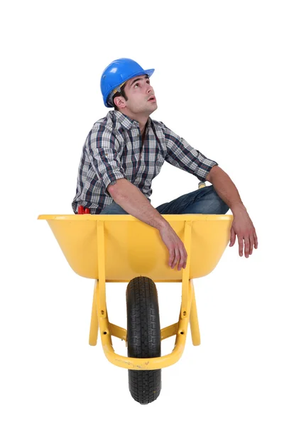 Foreman sitting in wheelbarrow isolated on white background — Stock Photo, Image