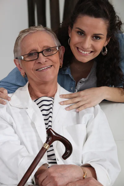 Granddaughter posing for the camera with her grandmother — Stock Photo, Image