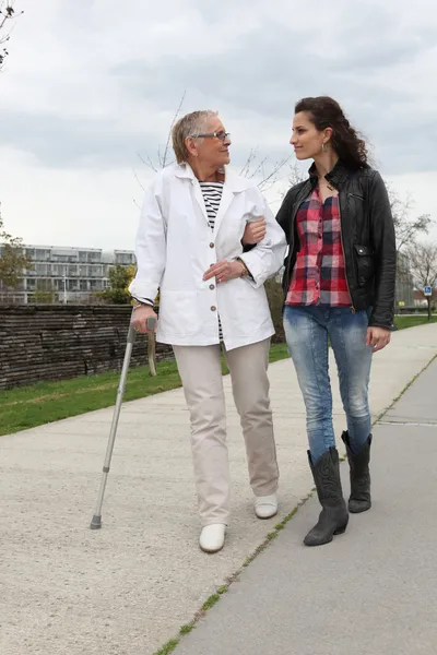 Young woman assisting a senior lady — Stock Photo, Image