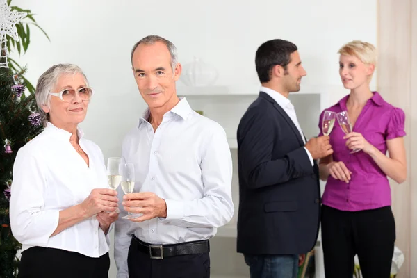 Two couples having champagne — Stock Photo, Image