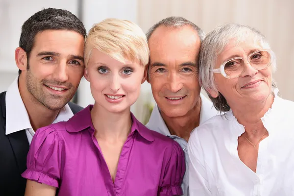 60 years old man and woman posing with 30 years old man and woman — Stock Photo, Image
