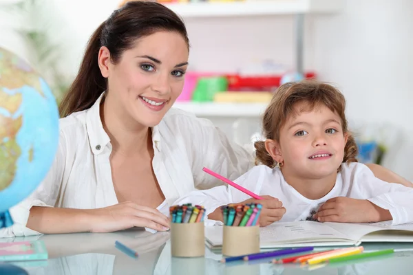 A female adult and a child girl drawing Stock Photo