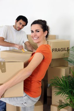 Couple unpacking their belongings clipart