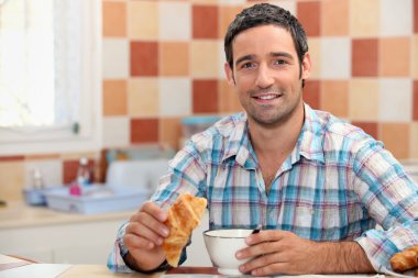 Man eating a continental breakfast clipart