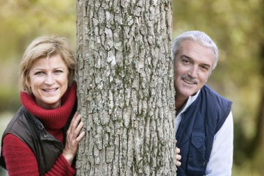 Married couple leaning against tree clipart