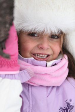 Young girl prepared for the cold clipart