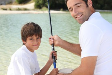 Father and son on a fishing trip clipart