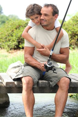 Father and son on a fishing trip clipart