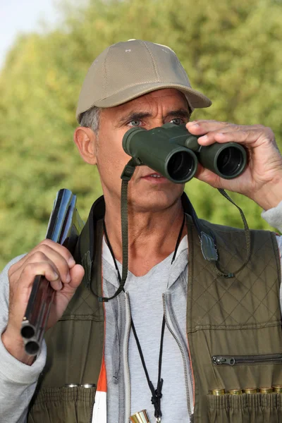 Hunter looking through binoculars — Stock Photo, Image