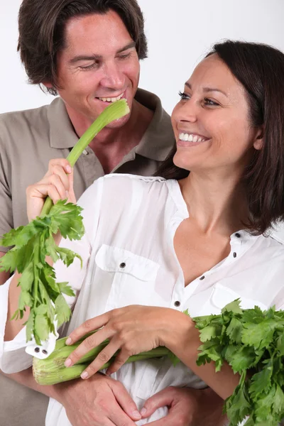Couple playing with celery — Stock Photo, Image