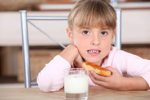 Little girl with jam and milk — Stock Photo, Image