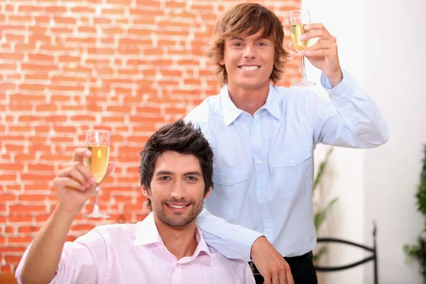 Two young professionals with champagne glasses — Stock Photo, Image