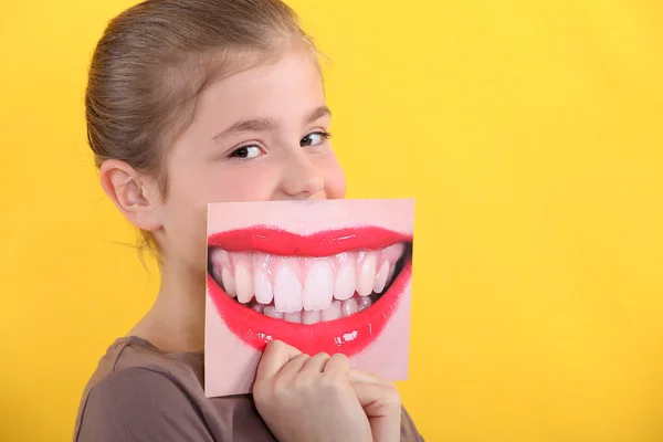Child holding a picture of a smile — Stock Photo, Image