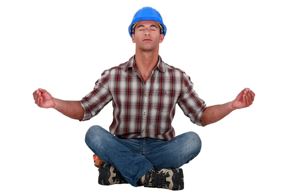 Laborer sitting in a yoga posture — Stock Photo, Image