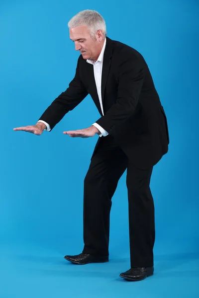 A mature businessman gesturing. — Stockfoto