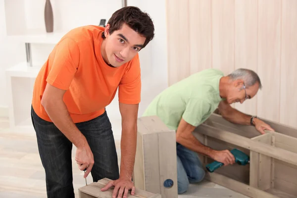 Two men fixing furniture — Stock Photo, Image