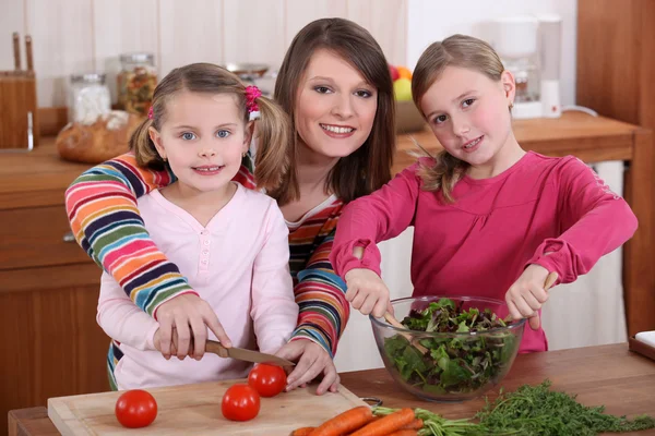 Mother and daughters cooking together — Stock Photo, Image
