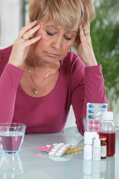 Woman sat in front of medication — Stock Photo, Image