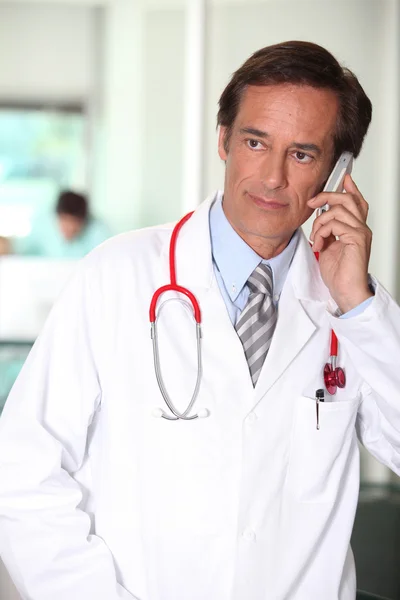 Médico del hospital usando un teléfono celular — Foto de Stock