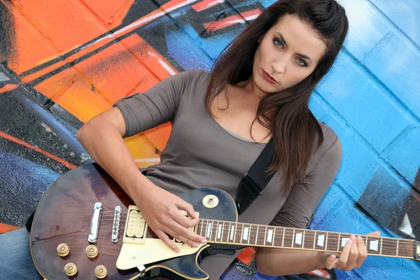 Musician with her guitar Stock Picture