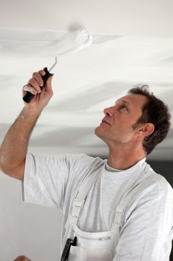 Man painting ceiling white clipart