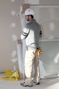 Man installing plaster board divide clipart