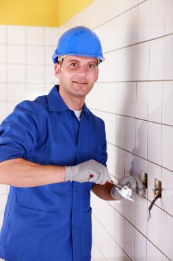 Electrician fixing bathroom socket clipart