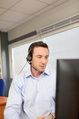 Office worker wearing a headset clipart