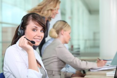 Women working in a call center clipart