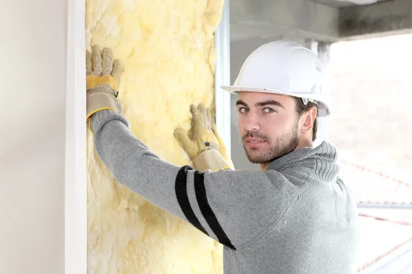 Worker installing new insulation — Stock Photo, Image