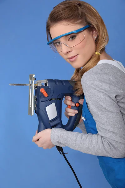 Attractive woman with band-saw — Stock Photo, Image